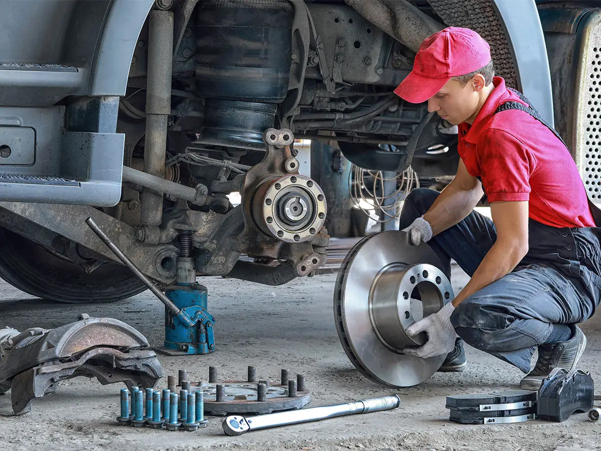Truck City Service technician inspecting a brake rotor at the Greeley, Colorado shop